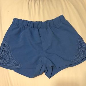 Blue high waisted shorts with lace detail